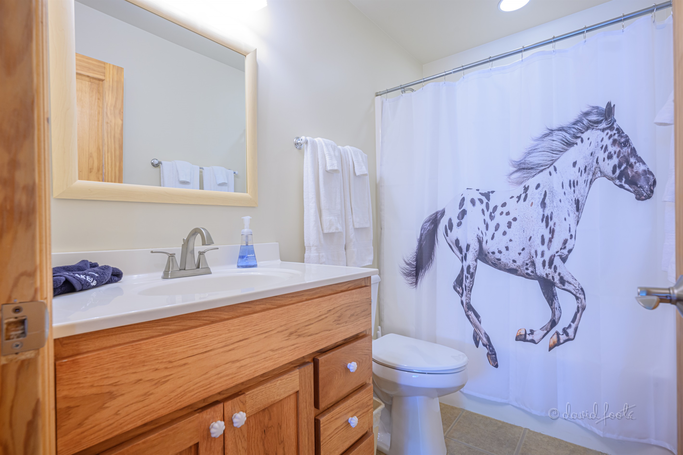 Upstairs full bathroom with shower/tub combination is shared by the two upstairs bedrooms