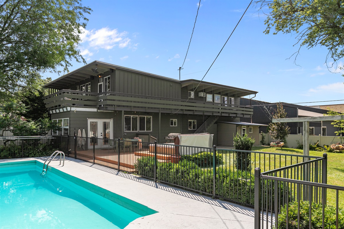 The backyard offers a wonderful space for the whole family to gather, whether for games, meals, or simply enjoying time together outdoors.