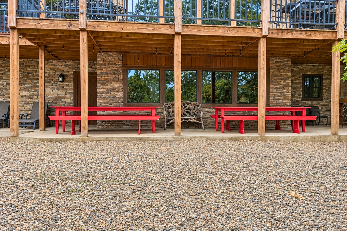 The lower outdoor area adds even more space to enjoy together, with bright red tables and plenty of room to gather beneath the deck.