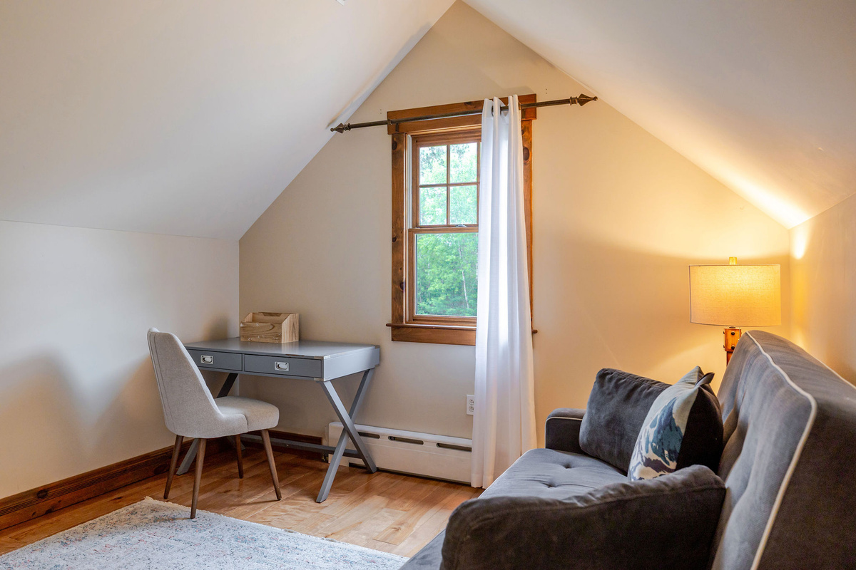 The upstairs bonus room with a pull-out sofa provides a quiet, comfortable sleeping and sitting area, and workspace.