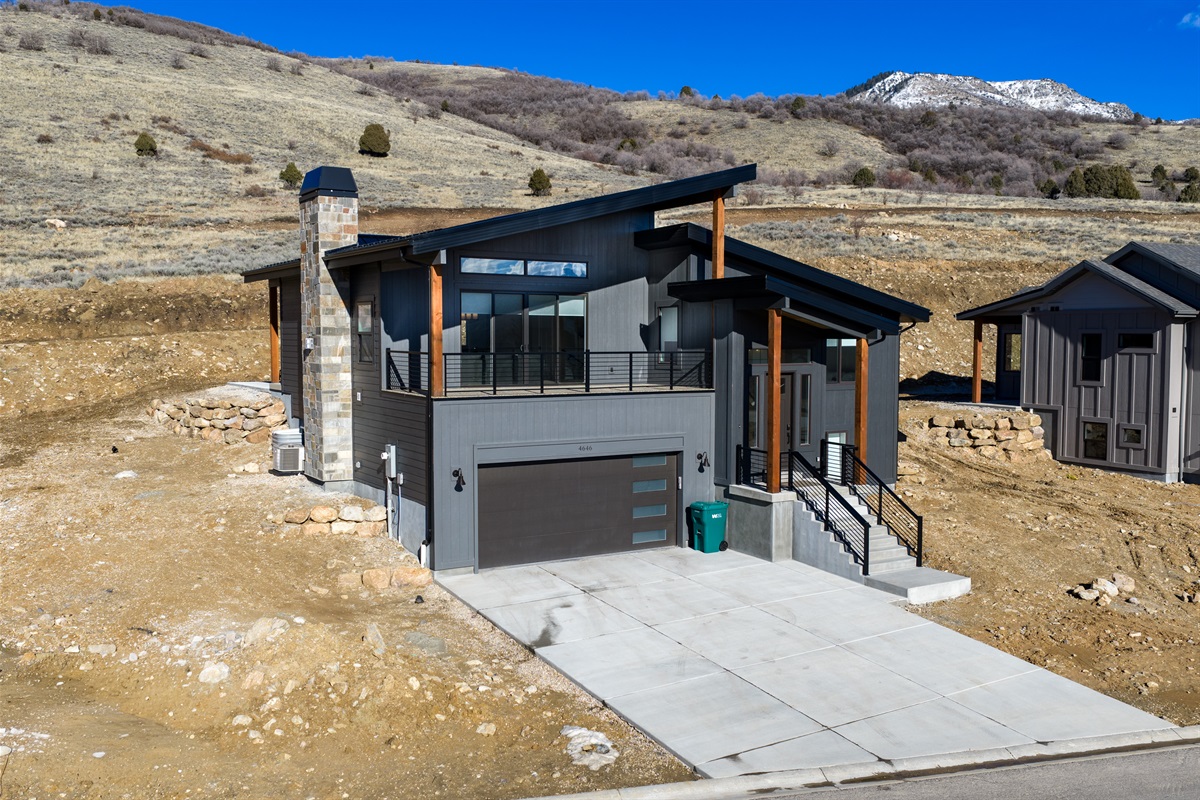 Striking modern mountain home with sweeping views and two car garage.