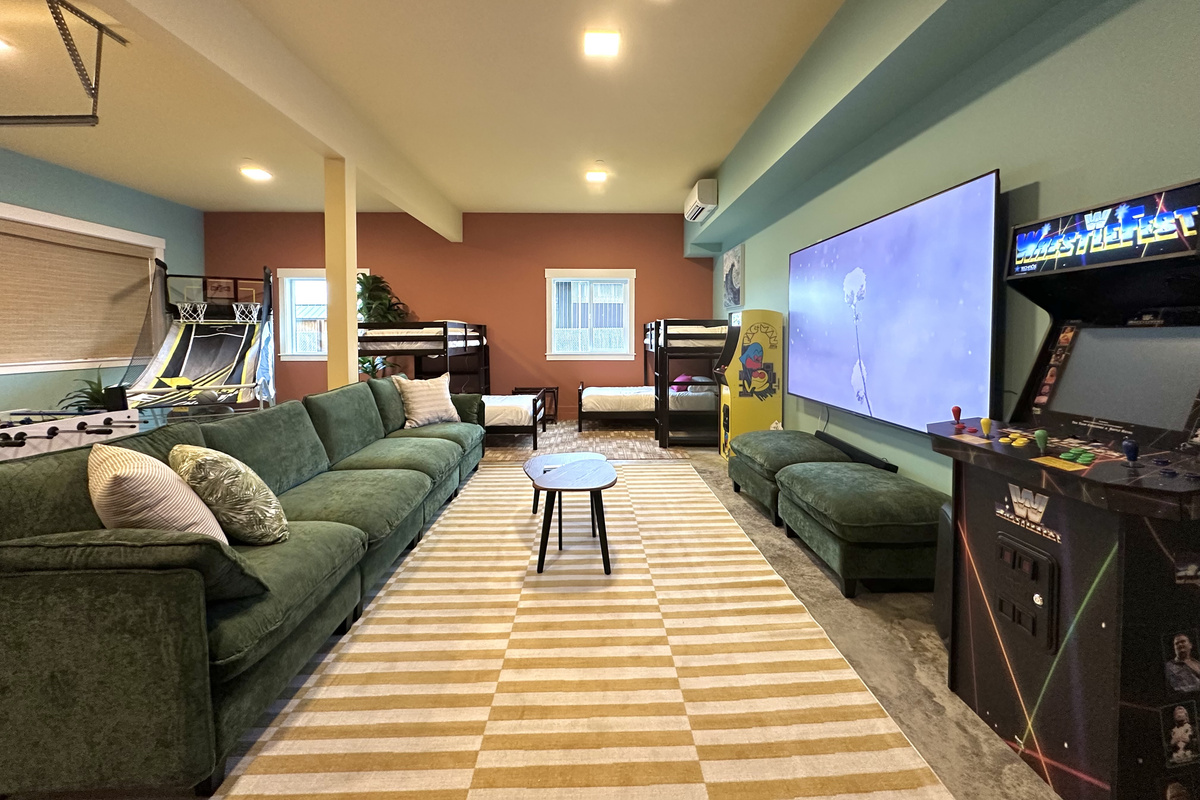 Movie nights and game nights run on the 100" screen downstairs, with seating that keeps everyone in the same room.