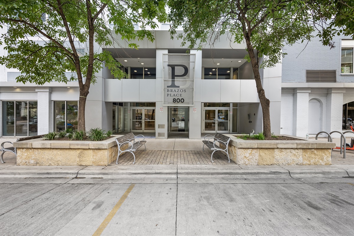 Front of the building, with 5 spaces reserved for dropoffs and grocery delivery.