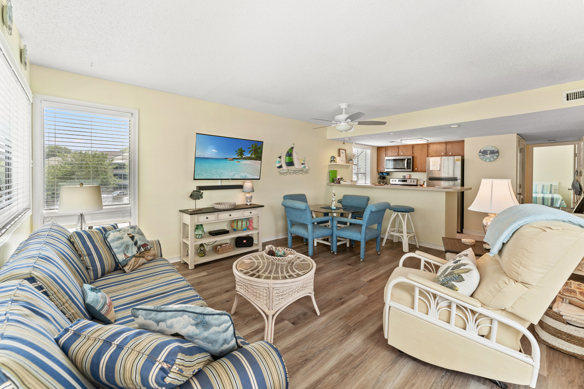 Spacious Living Room area with large TV and balcony access