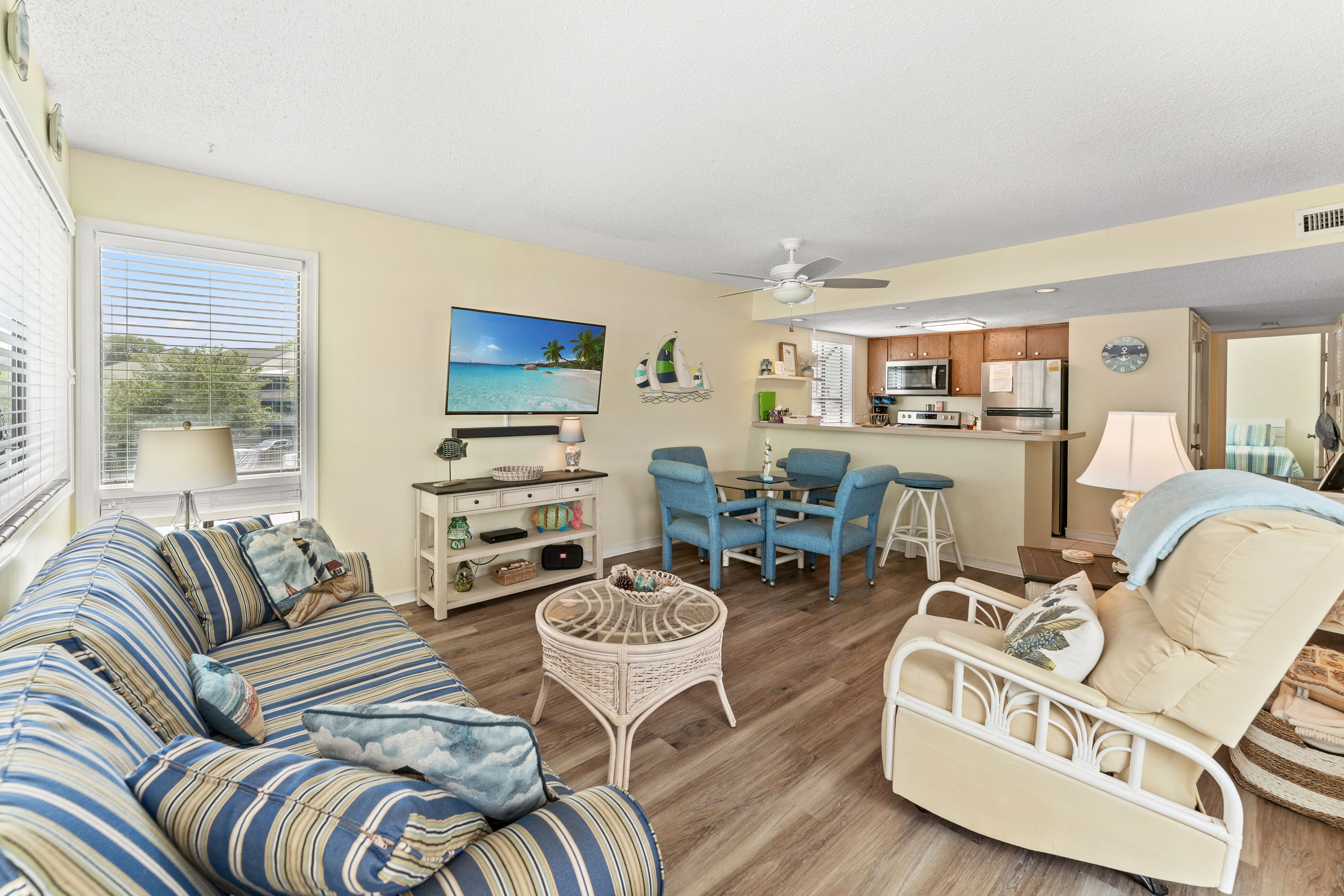 Spacious Living Room area with large TV, Sleeper sofa and balcony access