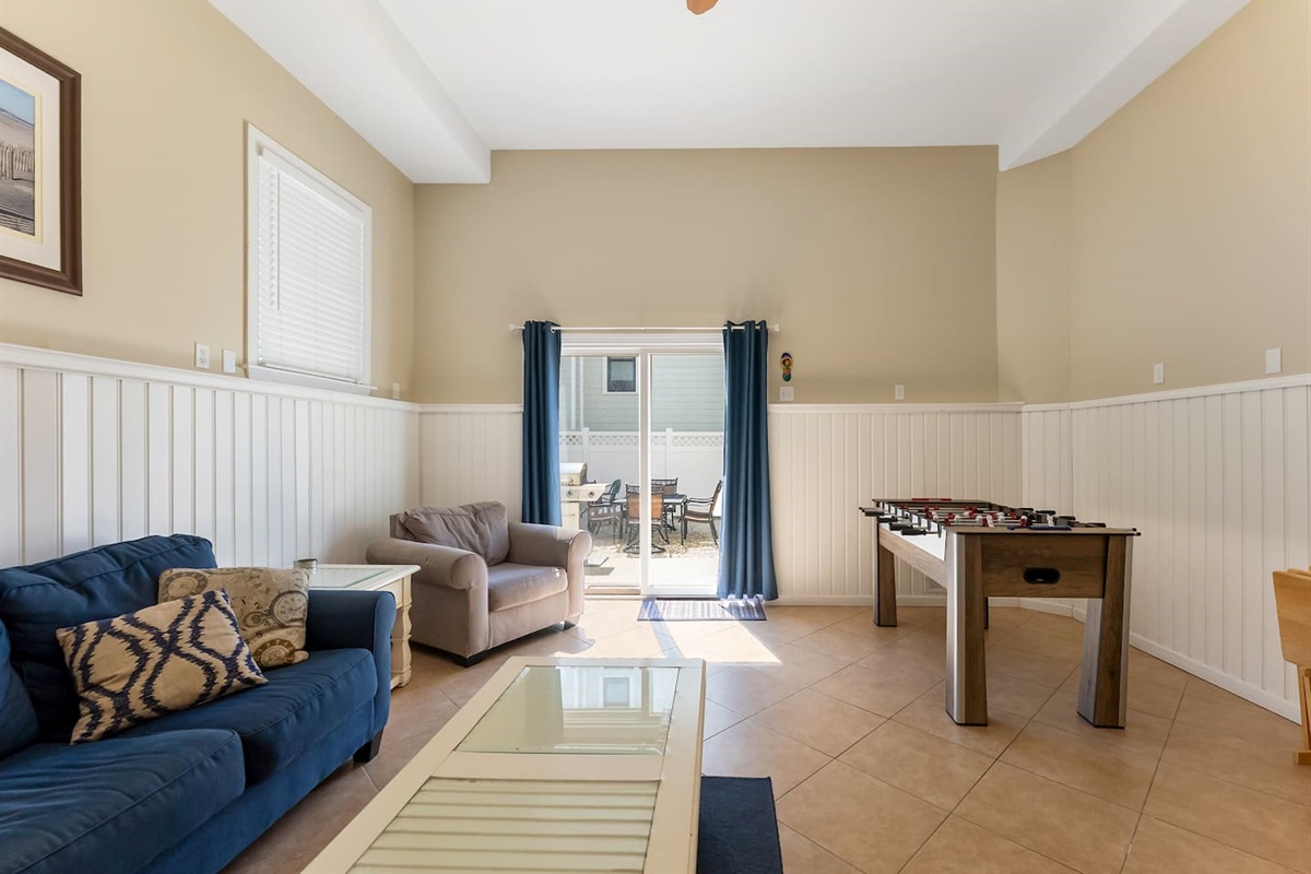 Bonus room with HDTV, Foosball Table, Bunk beds and ample seating for games and entertaining. With direct access to private fenced in yard featuring BBQ Grill. 