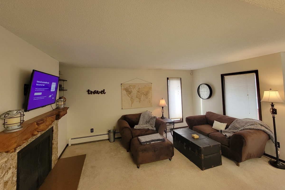 KP101APT5 - Living Room w/love seats, patio access, decorative fireplace, and Roku TV