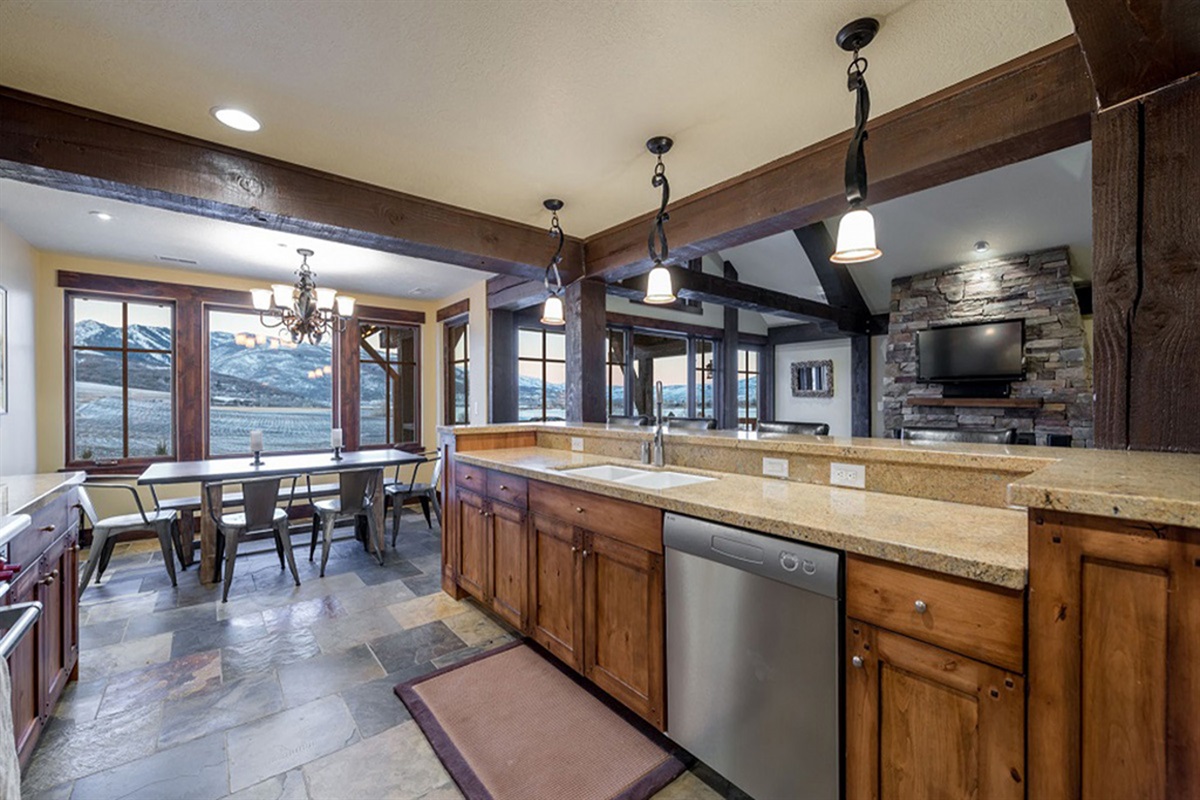 A beautifully integrated kitchen and dining space, where refined textures and abundant natural light create an elevated yet welcoming atmosphere with breathtaking mountain views.
