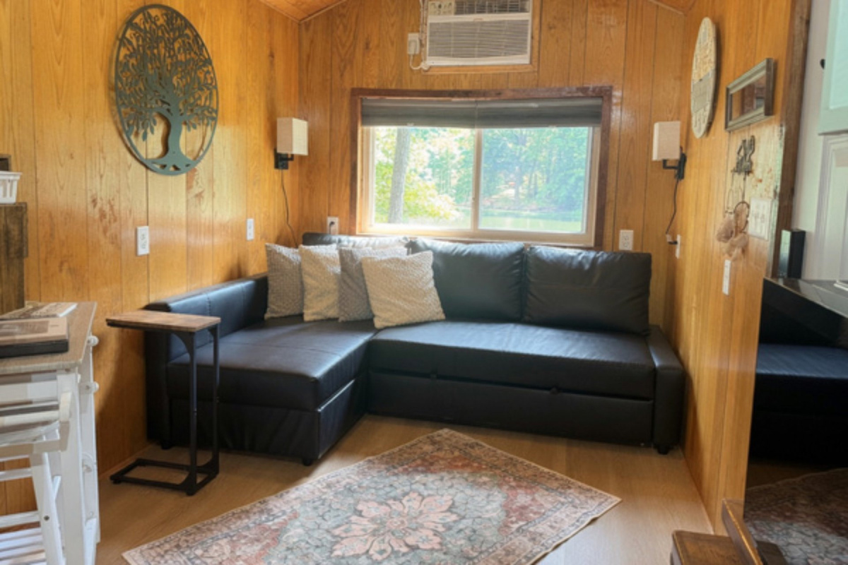 Cozy living area with pull-out sofa and peaceful lake views
