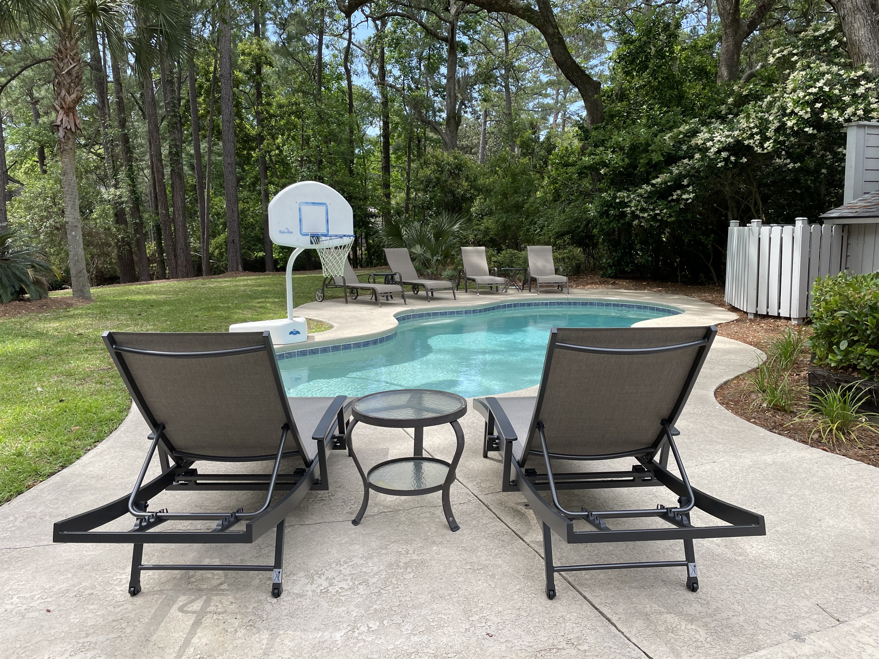 Enjoy pool and backyard from any of six chaise lounges
