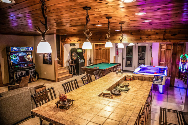 Game room with pool table, arcades, air hockey and a long table, Tanasi Lodge