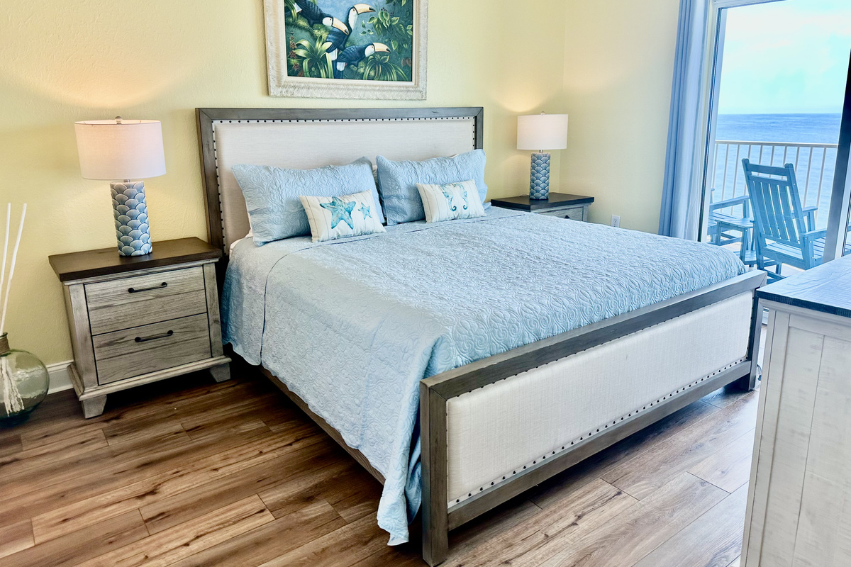 The master bedroom has a comfy king sized bed with access to the balcony. What a view to wake up to each morning!