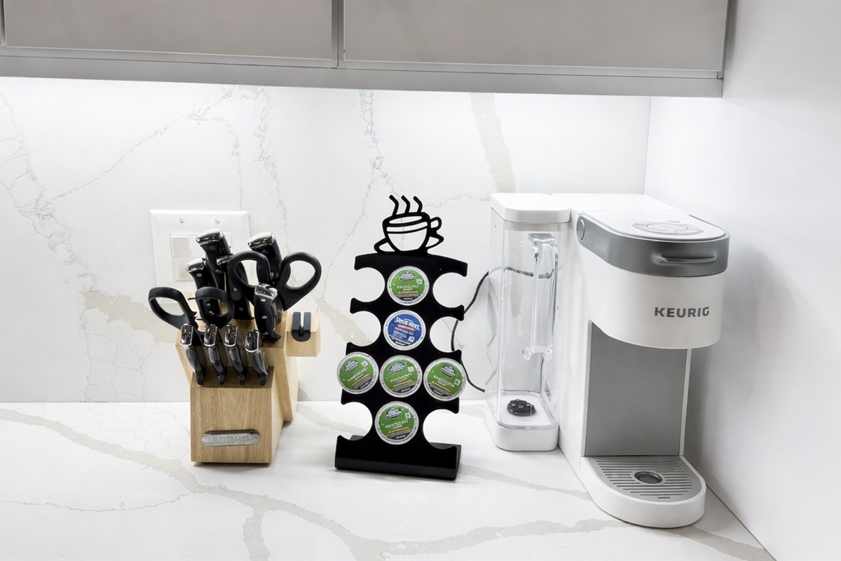 Keurig Coffee makers and knives set. Dishes and pots in the cabinets. 