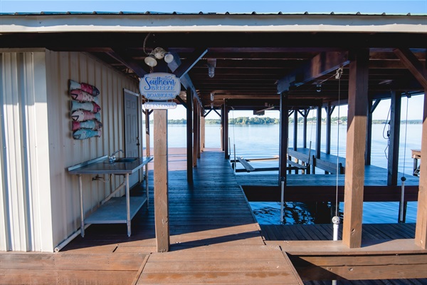 Boat dock includes a boat slip, sea doo slip, a fish cleaning station and a locked storage room.