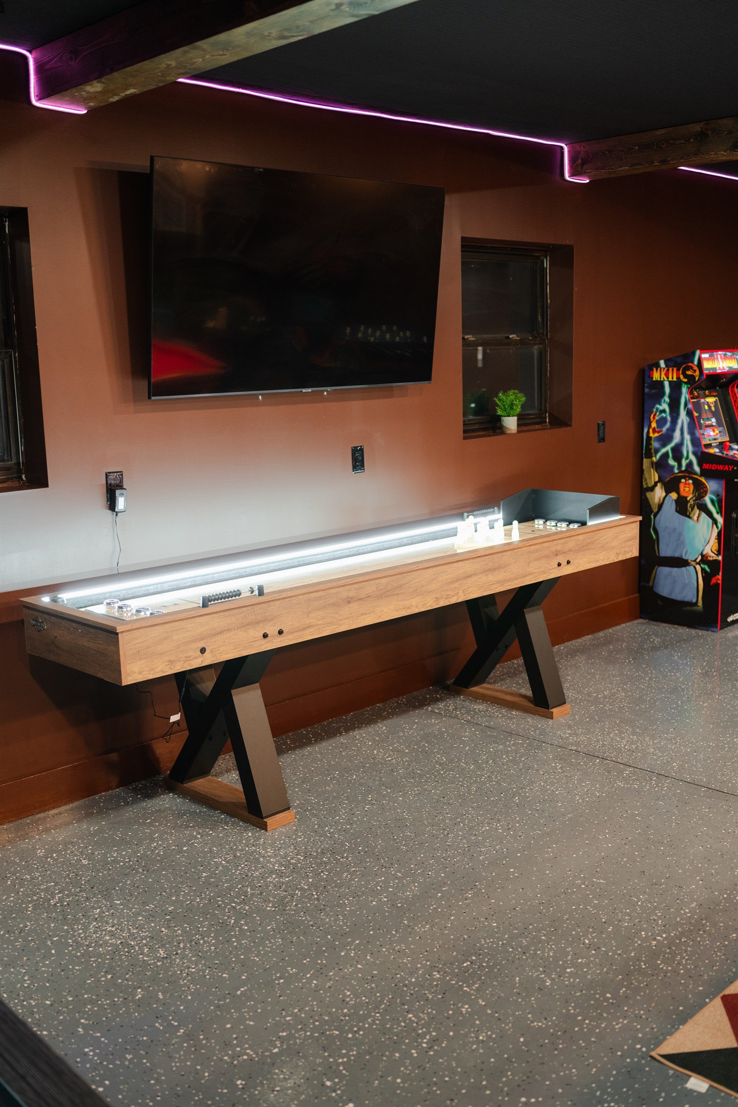 The shuffleboard table gives the game room another fun spot for a little friendly competition.