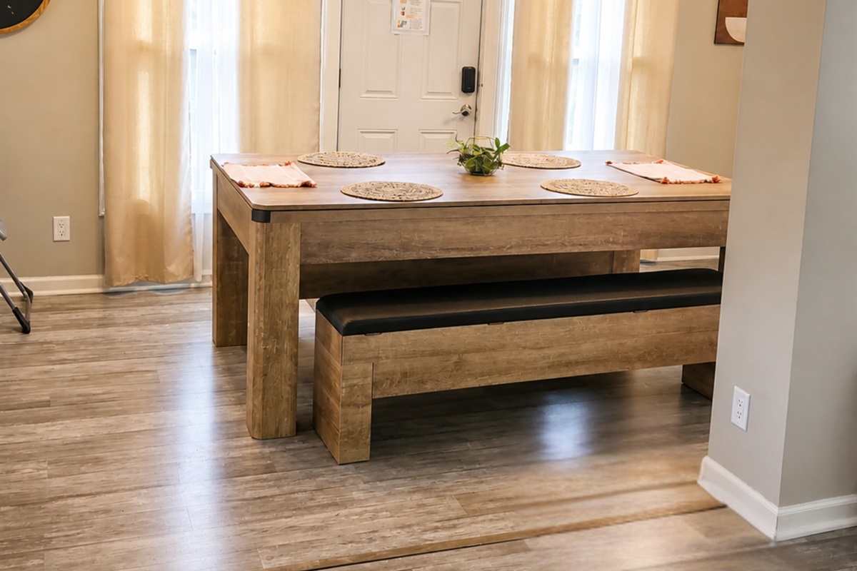 Spacious dining table seats 8 and opens directly to the fenced backyard