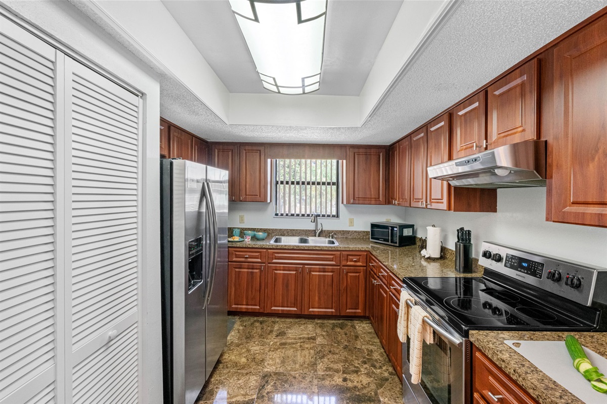 Paired with the rich cabinetry and glossy marble-look tile floors, the space feels both luxurious and functional.