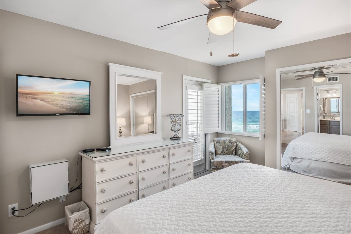 This stylish master bedroom boasts Gulf views, a King bed, balcony access, and a private bathroom