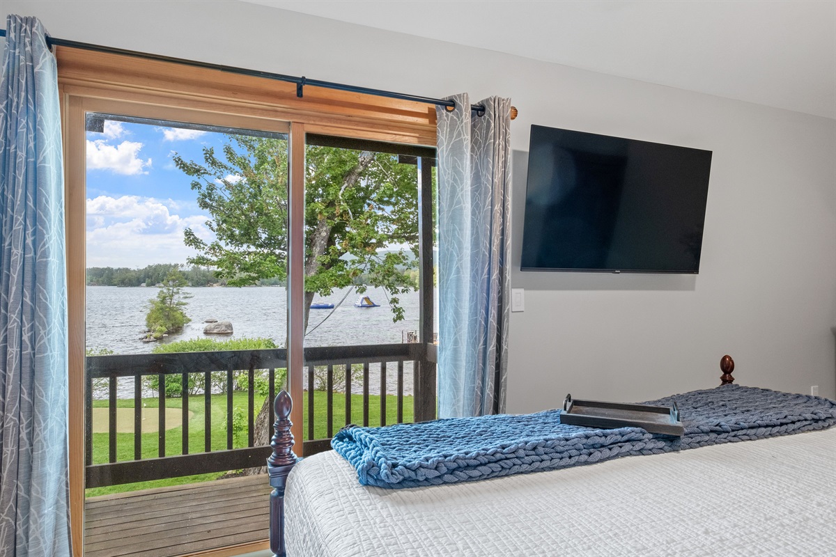 Second floor ensuite bedroom with king bed, balcony overlooking lake and its own full bath