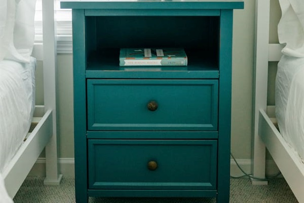 Nightstand with charging port. Books and earplugs available in the drawers. 