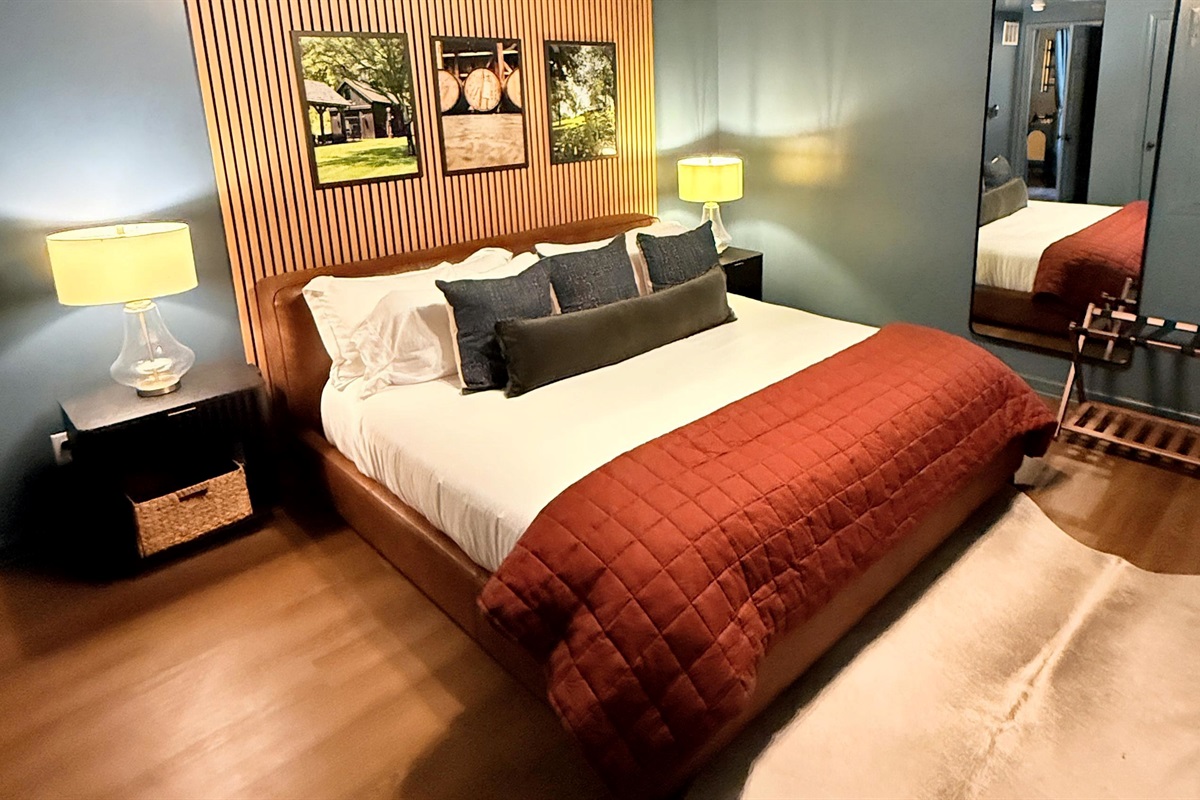 Texture meets tranquility — the slatted wall and layered design evoke quiet sophistication, where craftsmanship and comfort come together in true bourbon-country style, complete with USB-equipped nightstands for modern ease.