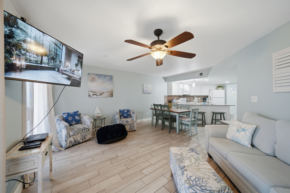 Living room with flat-screen TV and comfortable coastal-style seating