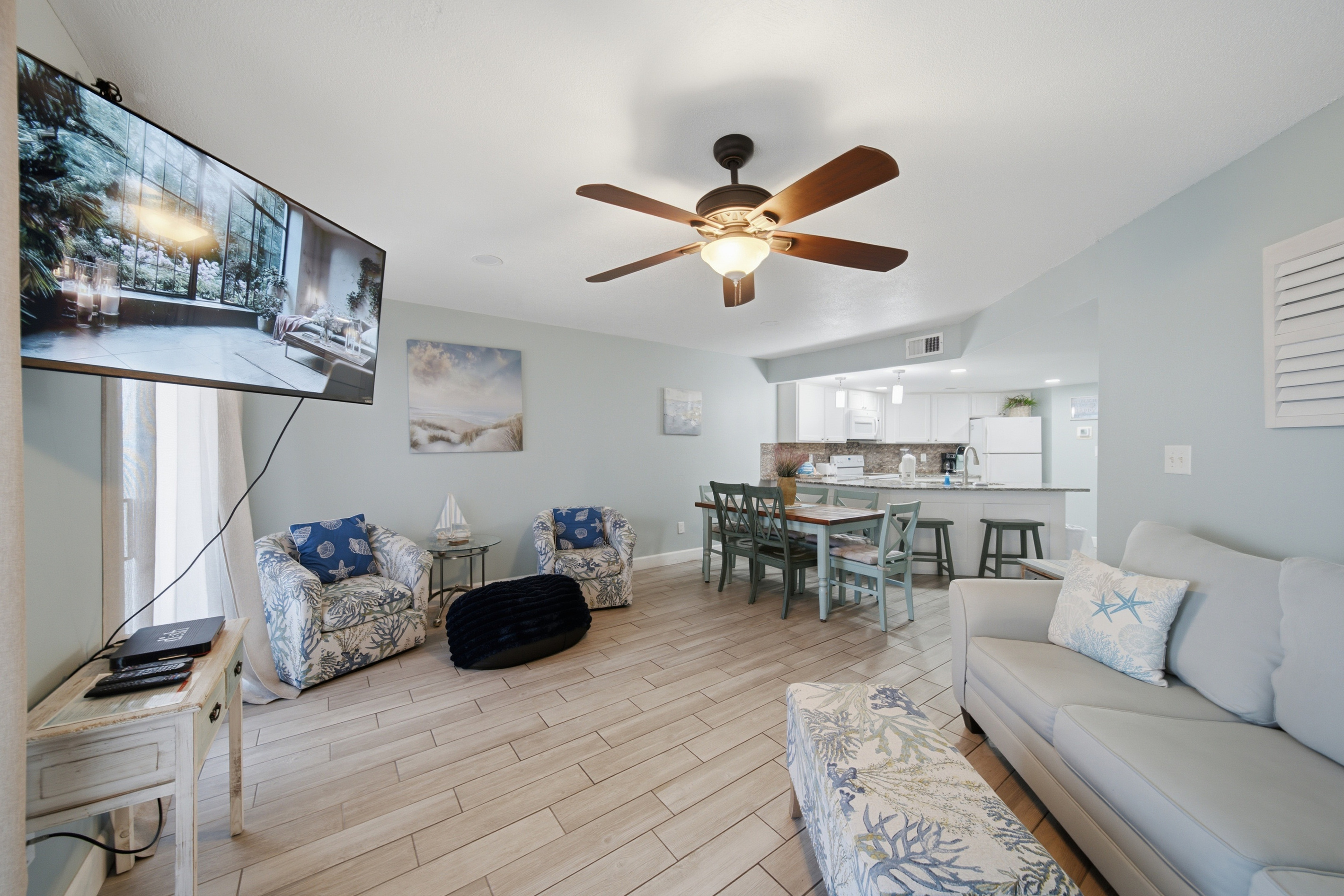 Living room with flat-screen TV and comfortable coastal-style seating
