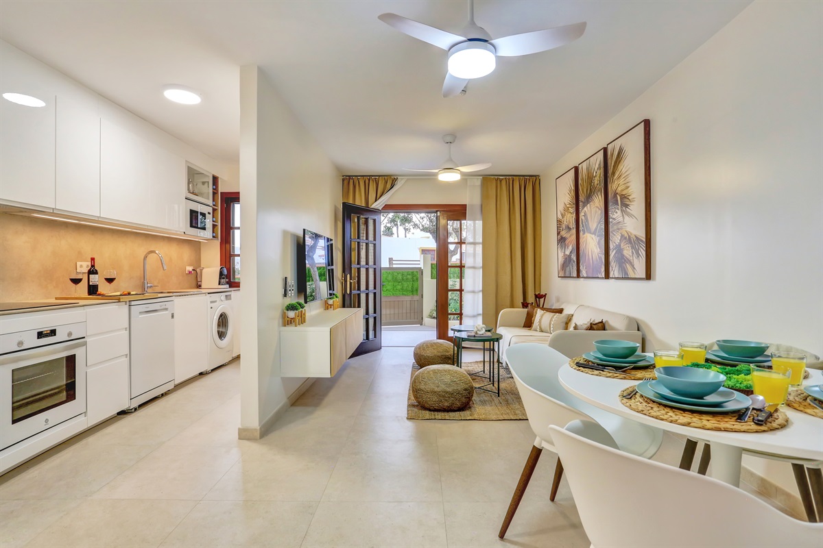 Spacious open-plan area combining a fully equipped kitchen, dining space, and living room, designed for comfort and a practical, enjoyable stay.