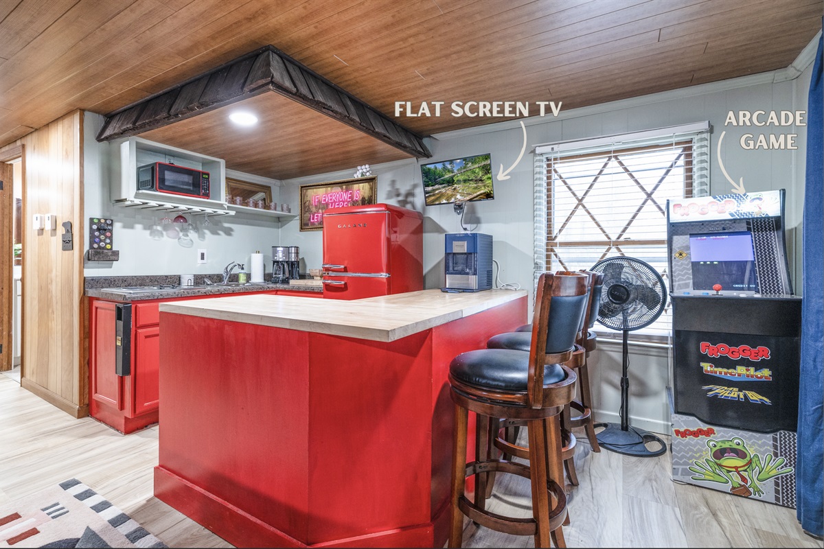 Enjoy modern comforts in our cozy kitchen featuring a flat-screen TV and a classic Frogger arcade game for nostalgic fun. 