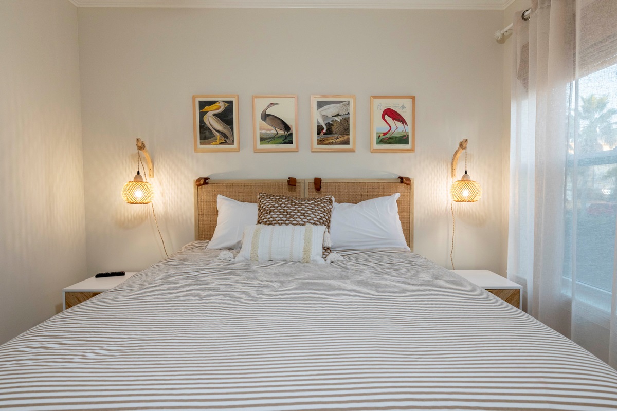 A soft, cozy bedroom with bay-inspired decor, warm lighting, and a relaxing coastal vibe.