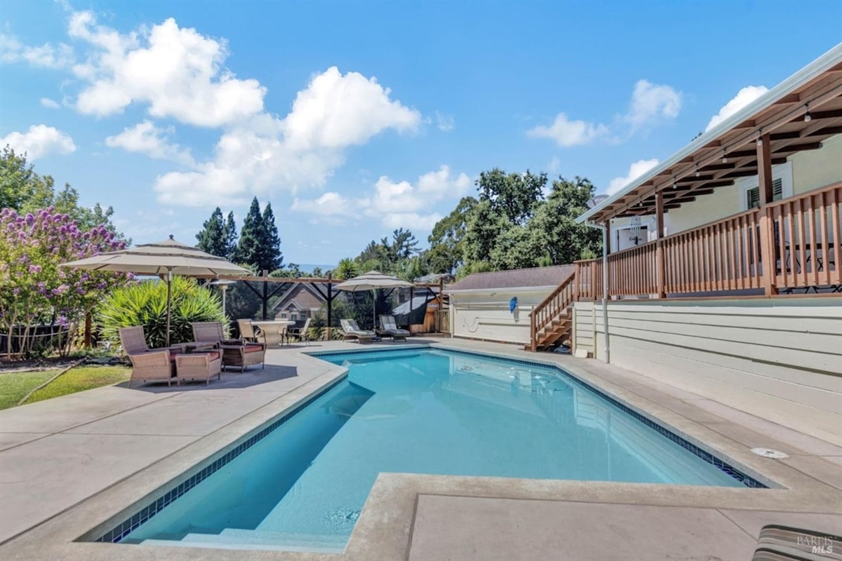 Backyard with pool, hot tub, and pool hosue bathroom.