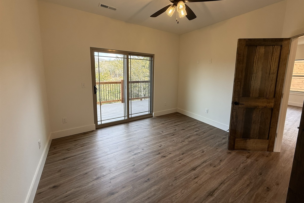 Bedroom 1 - Main Level with with ensuite bath and access to the private deck