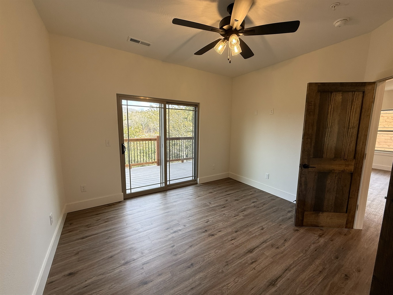 Bedroom 1 - Main Level with with ensuite bath and access to the private deck