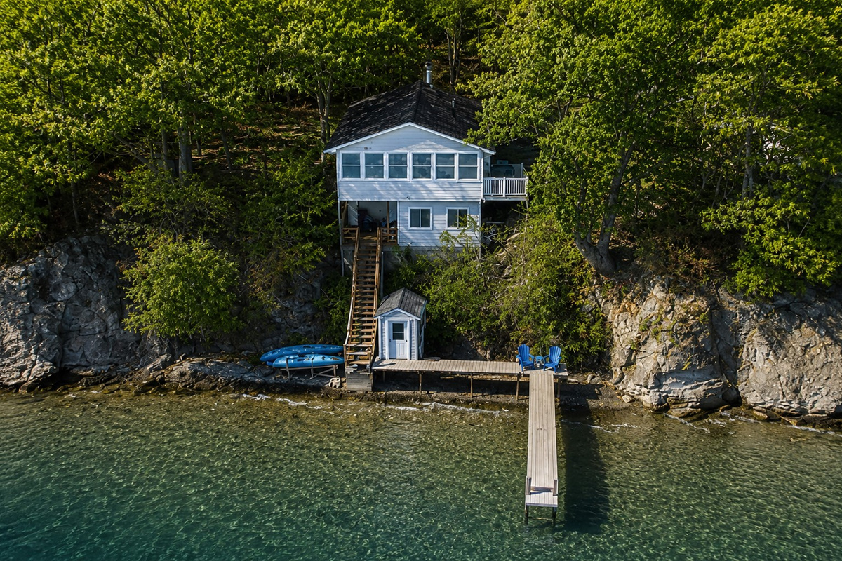 Iconic blue lake house perched above the dock—unmatched water views from every angle