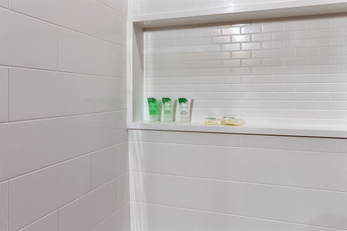 Bathroom features an upgraded shower enclosure, complete with complimentary shampoo, conditioner, lotion and bar soap to get you started!