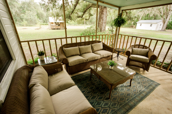 The screened back porch - a second living room overlooking the yard.