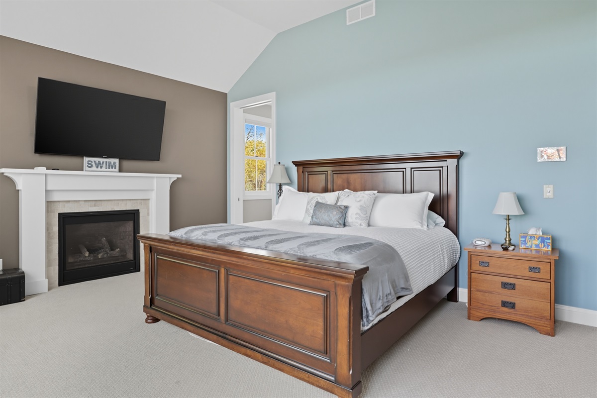 Cozy second floor king master bedroom with ensuite bathroom, private balcony, fireplace and flat-screen TV. Bedroom #1