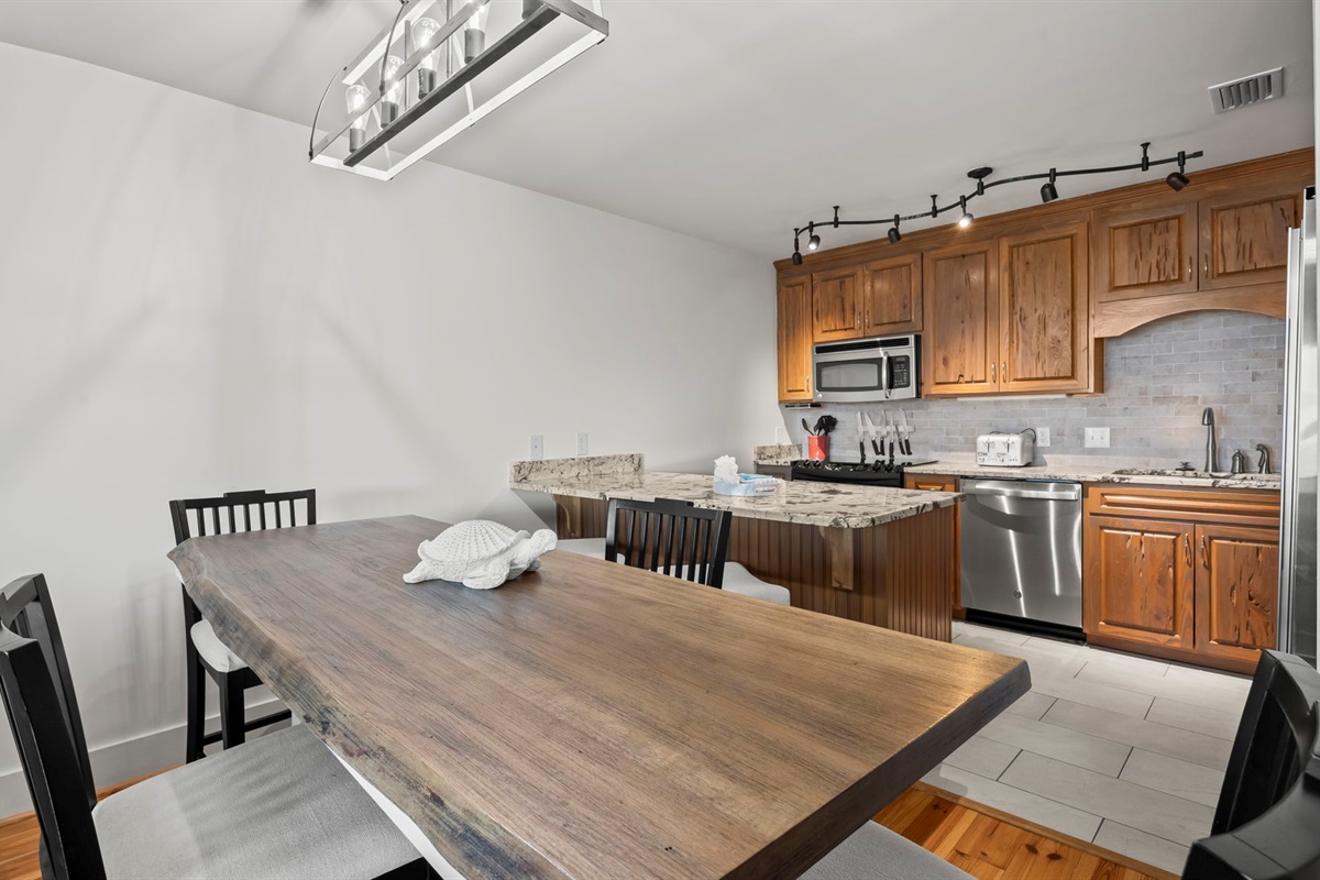 Enjoy meals together at the dining table in our Cotton Bayou condo, offering a comfortable and inviting space for family dinners or casual gatherings. Perfectly situated near the updated kitchen for added convenience.