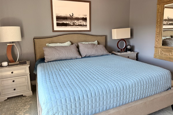 Primary bedroom with king sized bed and attached balcony with a sitting area perfect for a morning coffee with a view.