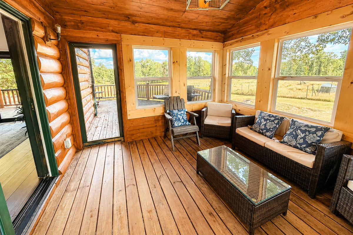 Panoramic view form the sunroom windows overlooking the surrounding Northwoods property. Step through the door onto the large deck. 
