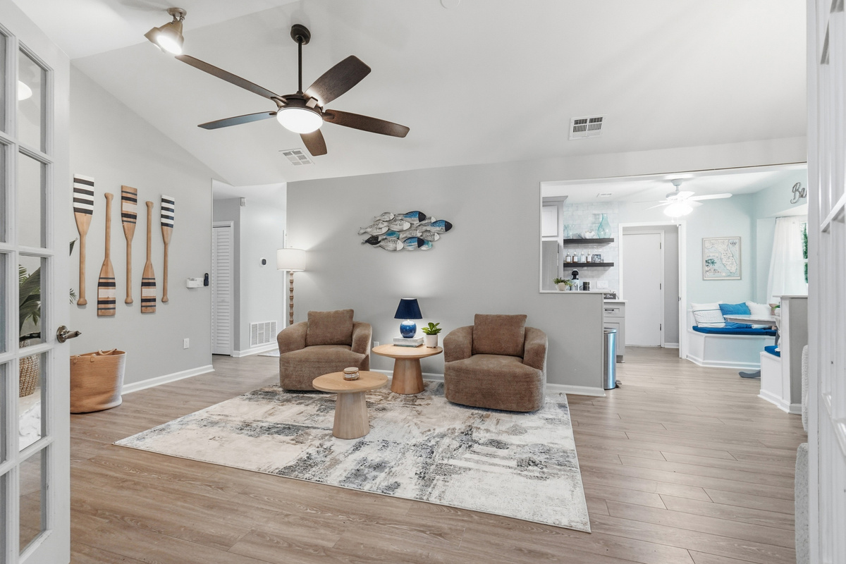 The open living room connects easily with the kitchen, breakfast nook, and game room.
