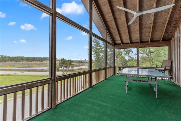 Front screened porch with ping pong table and outdoor lounge couch