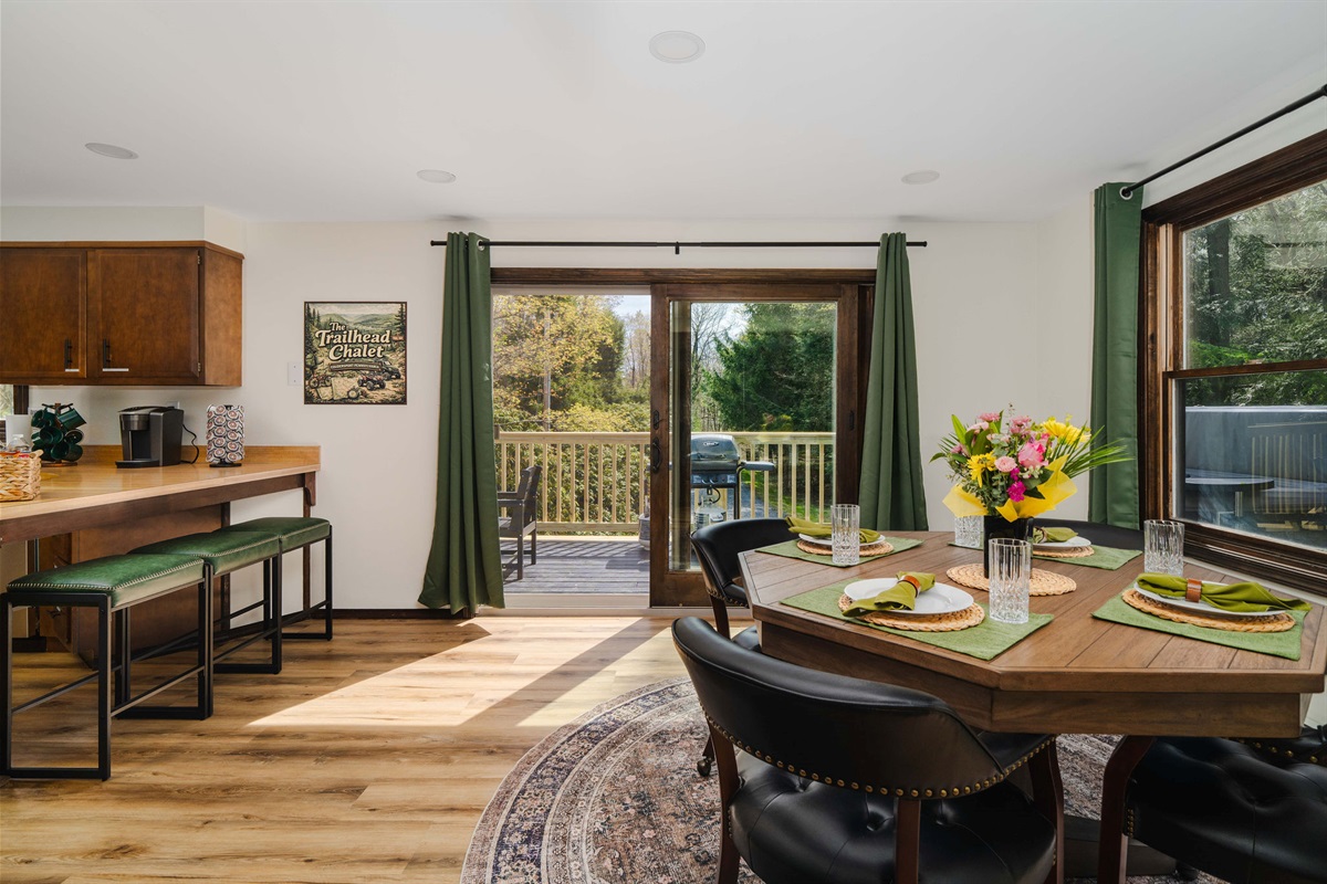 ☀️ The dining area soaks in natural light through big forest-facing windows.