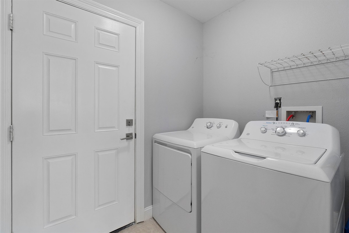 Conveniently located near the entry, this space also includes an overhead shelf for laundry essentials, making it easy to stay organized during your stay.