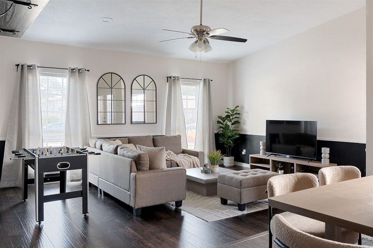Relax on the comfortable couch next to the 65" HDTV or stand for a game of foosball
