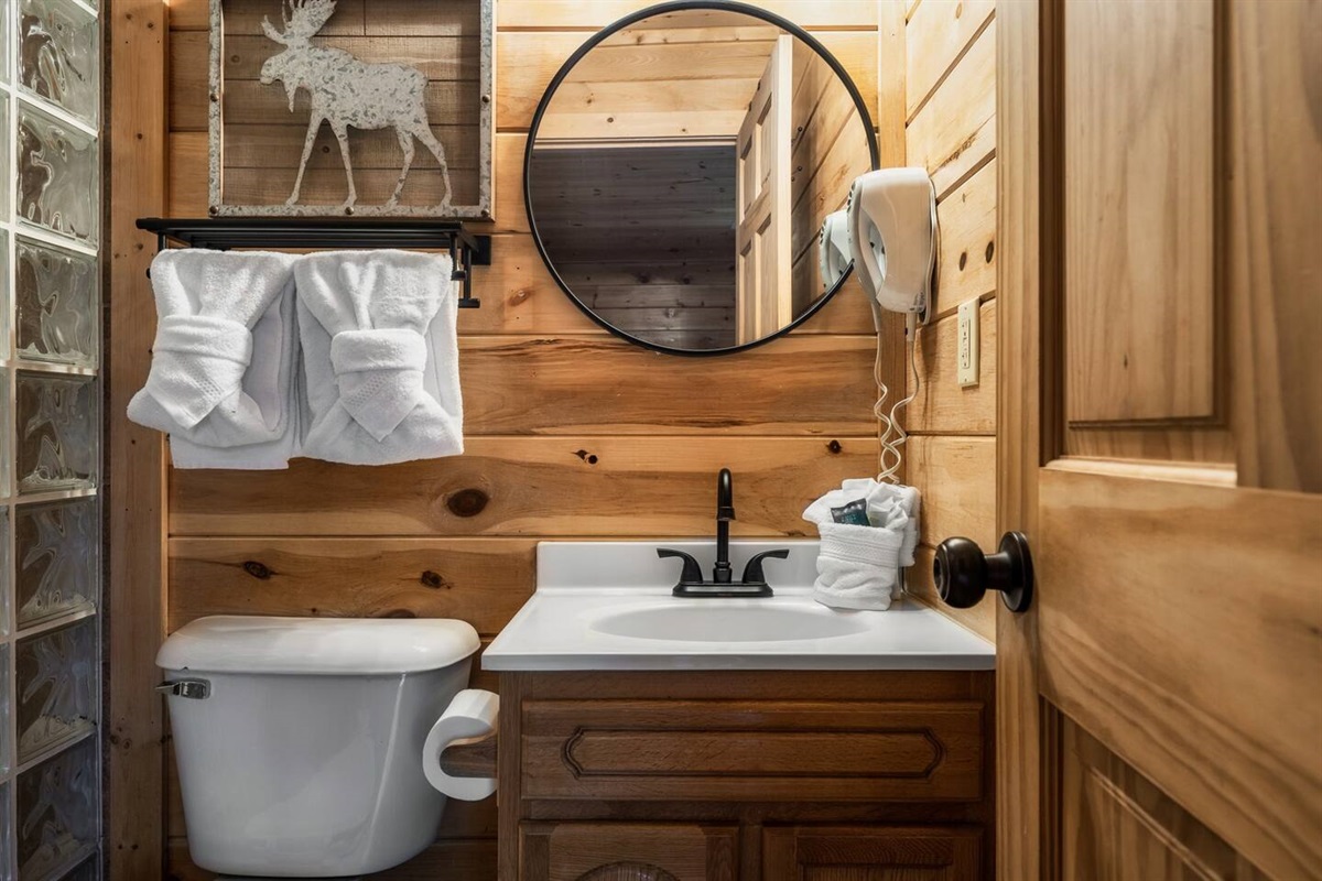 Modern-designed Bathroom, highlighted by its wooden walls and a beautifully crafted sink.