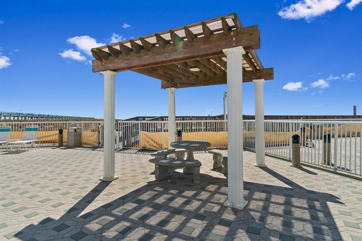 When you're ready for a break from the beach, the shaded pergola area offers a comfortable place to relax outdoors.