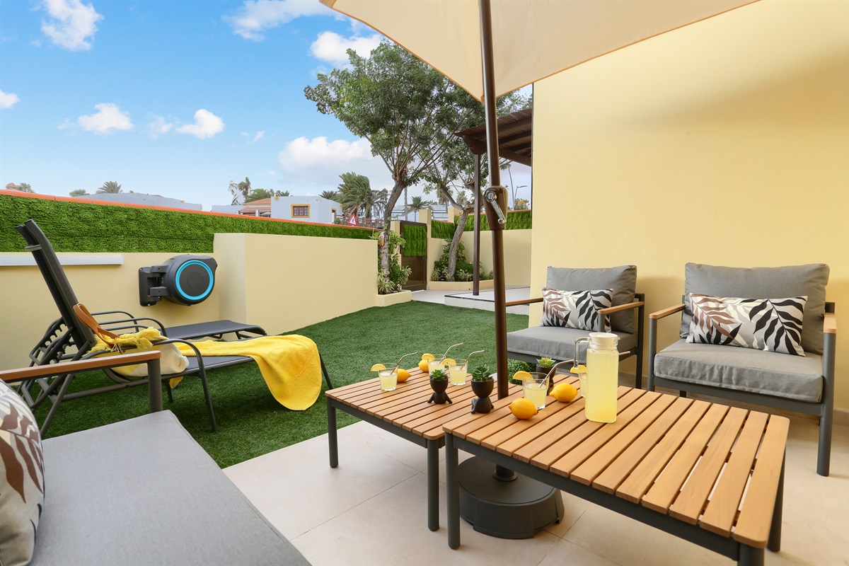 Spacious outdoor area with garden furniture, sunbeds, and space to relax and enjoy the outdoors in total comfort.