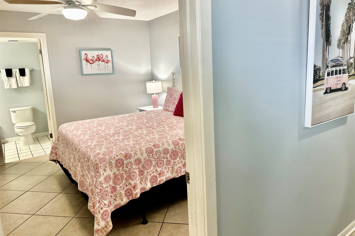 When you open the door to the condo, the guest bedroom is the first room you'll see.