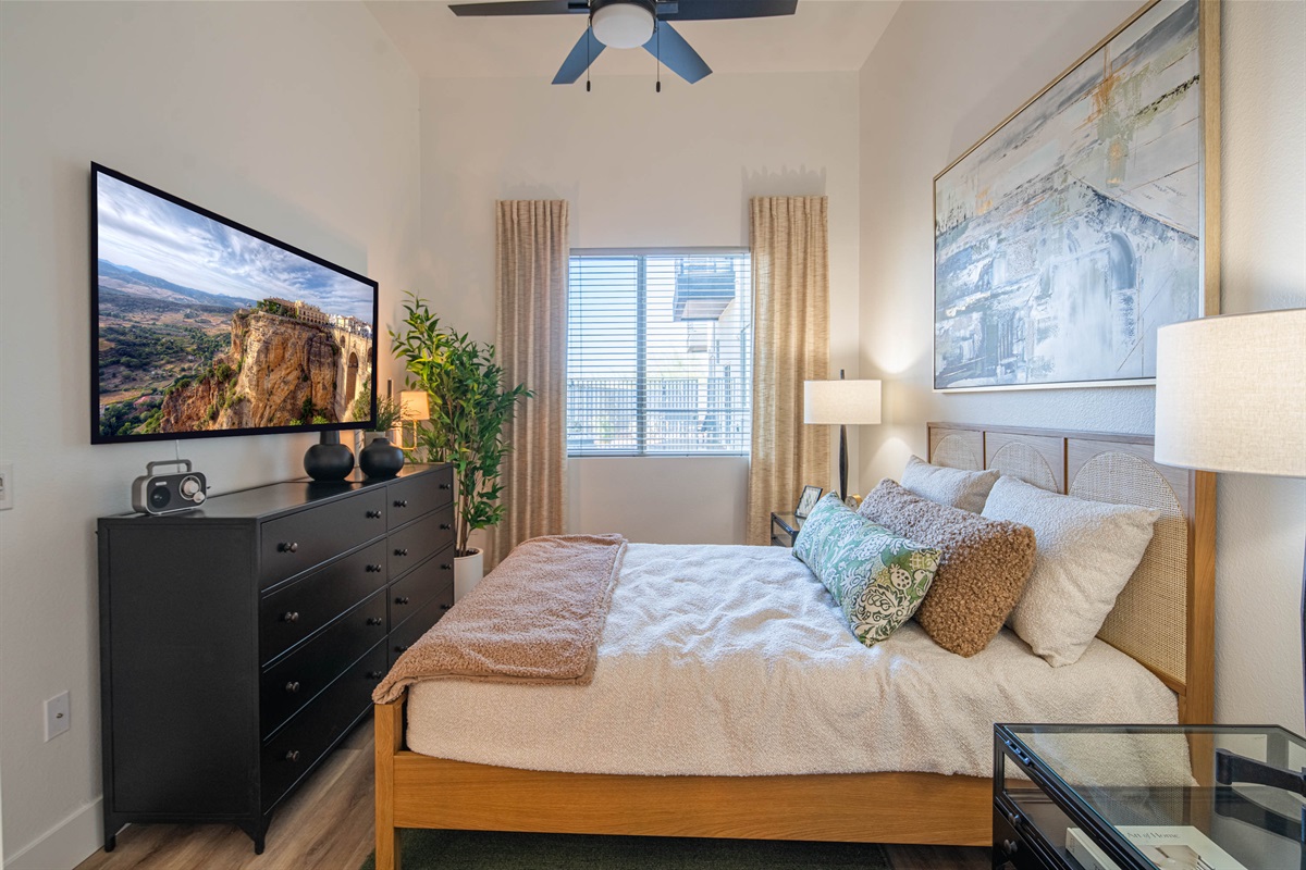 Queen bed. A tranquil bedroom designed for relaxation, with a plush bed, calming colors.